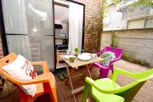 a small patio with a table and colorful chairs at KITAZAWA CS HOUSE / Vacation STAY 78552 in Tokyo