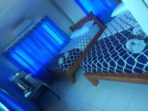 einen Blick über ein Bett in einem Zimmer mit blauen Lichtern in der Unterkunft ต้นค้อ สวีทโฮม in Khao Kho