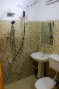 a bathroom with a shower and a sink at Jaya Villa in Negombo