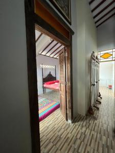 a doorway into a bedroom with a bed in a room at Gemyah in Glagah