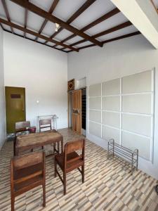 a room with two wooden tables and two chairs at Gemyah in Glagah