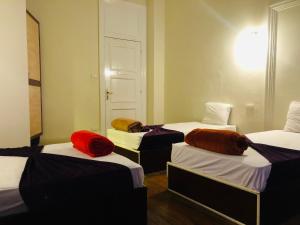 a room with four beds with different colored sheets at OH! Cairo Pharaoh Hostel in Cairo +19 photos