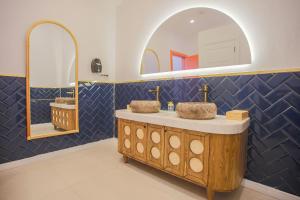 a bathroom with two sinks and a mirror at Glenn Hotel & Beach in Ayvacık +162 photos