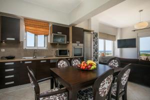 Al Mare Apartments في أفانتو: مطبخ مع طاولة عليها صحن من الفواكه