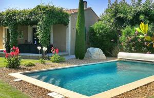 a swimming pool in front of a house at Villa Nathis in Maillane