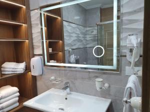 a bathroom with a sink and a mirror at Le Sélect Appartement in Nador +20 photos