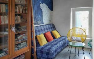 a blue couch with colorful pillows in a room at 3 Bedroom Awesome Home In Carpentras in Carpentras