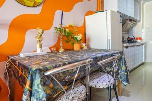 a kitchen with a table and a refrigerator at SKYINN Aparment 橙堡整套复式公寓 in Shenzhen