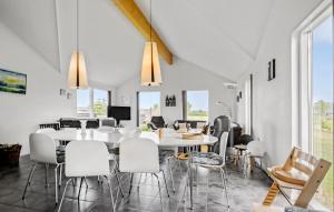 a dining room with a white table and chairs at Holiday Home Flovt Havevej V in Flovt