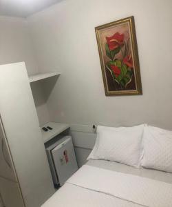 Giường trong phòng chung tại Pousada Central