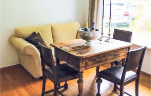 a dining room table with chairs and a couch at 4 Bedroom Nice Home In Eidfjord in Eidfjord