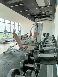 a gym with several rows of tread machines at kozi mama paradise in Kuching