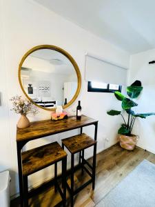 a dressing table with a mirror and a stool at Stylish tiny home in Melton west in Melton
