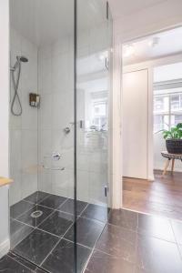 a bathroom with a shower with a glass door at VAQUAY Tribeca in Melbourne CBD in Melbourne