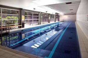 a large swimming pool in a building at VAQUAY Tribeca in Melbourne CBD in Melbourne