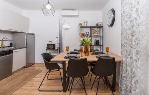 a kitchen and dining room with a wooden table and chairs at Awesome Home In Bribir With Jacuzzi in Bribir