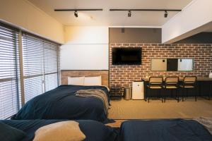 a room with a bed and a table and chairs at Hotel Akasaka Heights in Fukuoka +9 photos