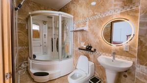 a bathroom with a shower toilet and a sink at Miha Villa Can Tho in Can Tho