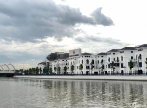 a large white building next to a body of water at HPT II Apartment chuỗi căn hộ Hải Phòng in Hai Phong