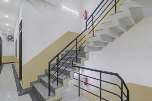 een trap in een gebouw met metalen reling bij OYO Flagship The Classio Grand in Chinhat