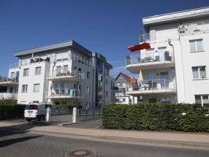 Una camioneta estacionada frente a dos edificios blancos en Nordic Comfortable holiday residence, en Bansin