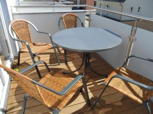 a table and two chairs on a balcony at Tacke 2 Comfortable holiday residence in Burg auf Fehmarn