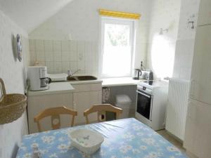 a kitchen with a table and two chairs and a table and a table at Jacobi Comfortable holiday residence in Bad Harzburg