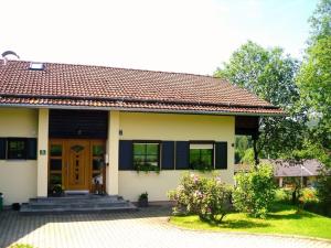 a small white house with a brown door at in the country house at the national park in Lindberg