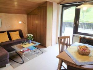 a living room with a couch and a table at Haus Fernblick Apartment 2 in Bad König