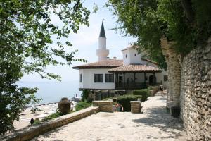 a building on the beach with a church at Beachside Bliss by Mery -Balchik in Balchik