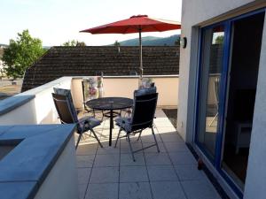 a patio with a table and chairs and an umbrella at Tacke 5 - Penthouse Bodenwerder - in Bodenwerder