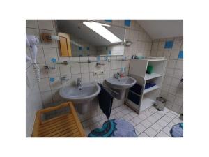 a bathroom with two sinks and a mirror at Anna Geißinger Comfortable holiday residence in Mauth +31 photos