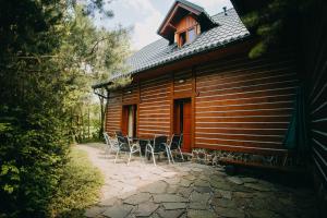 a house with chairs and a table in front of it at Chalupa s privátní saunou in Dolní Morava