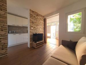 a living room with a couch and a television at Kocevar 4 Comfortable holiday residence in Portorož +28 photos