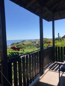 a view of the ocean from the porch of a house at Вила Стела in Sinemorets