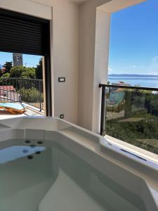 a bath tub with a view of the ocean at Ivana&Luka-superior wellnes in Brela