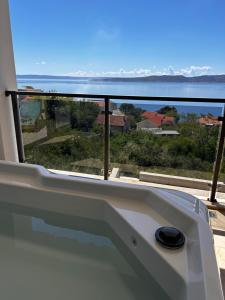 a bath tub with a view of the ocean at Ivana&Luka-superior wellnes in Brela