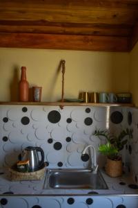 a kitchen sink with a polka dot wall at Salty Alchemy in Arugam Bay