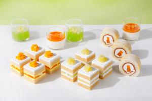 a group of desserts on a white table with glasses at Hotel New Otani Tokyo The Main in Tokyo