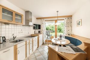 a kitchen with a table and a dining room at Apartments Scherlin in Castelrotto