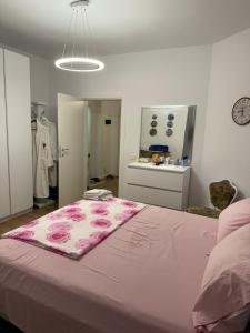 a bedroom with a bed with a pink blanket on it at Luli apartment Durrës in Durrës +2 photos