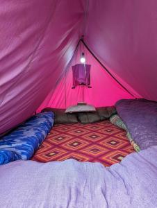 a pink tent with a bed in it at Kedar Tent House in Kedārnāth