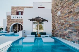 布拉卡的住宿－Aegean Palace，一座带椅子和遮阳伞的游泳池位于大楼旁