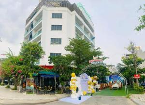 a large white building with a lot of balloons in front of it at Quỳnh Anh Luxury Hotel Sầm Sơn in Sầm Sơn