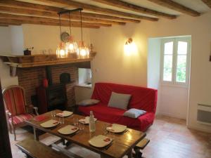 a living room with a red couch and a table at Bouerzy in Laruns