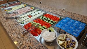 a buffet with different types of food on a counter at Hotel Florida Mamaia in Mamaia
