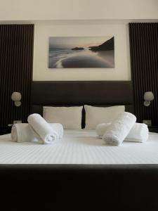 a bedroom with a bed with white sheets and pillows at Hotel Lula Ksamil in Ksamil