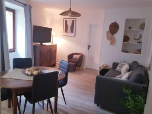a living room with a table and a couch at La Calade in Barnave