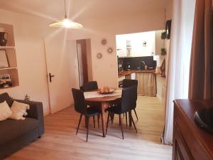 a dining room with a table and chairs and a kitchen at La Calade in Barnave
