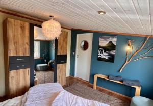 a bedroom with a bed and a blue wall at Go out stay wild in Norsjö